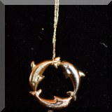 J08. Gold dolphin pendant. 